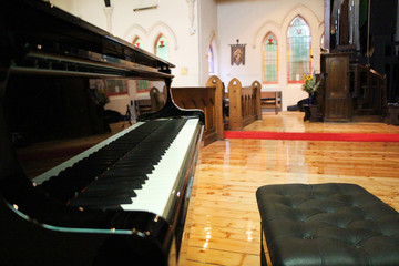 Black grand piano in a church
