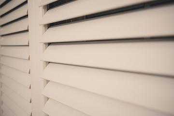 close up of window shutters in a room during night time