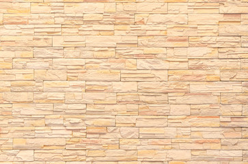 background and texture of yellow decorative  stone wall surface.