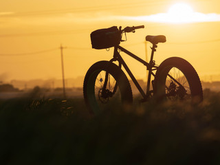 Fototapeta na wymiar Bicycle in sunset and romance lanscape