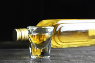Bottle of Mexican tequila with a glass ready to drink