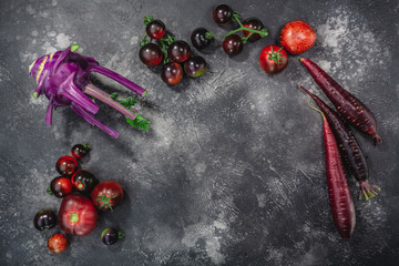 Anthocyanin-rich vegetables on dark textured backdrop,  top view