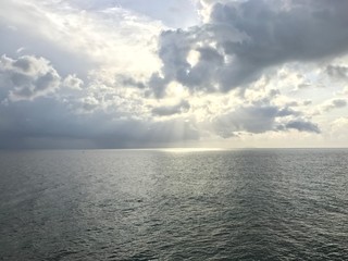 Fototapeta premium View of the atlantic ocean with the sun peeking through the clouds.