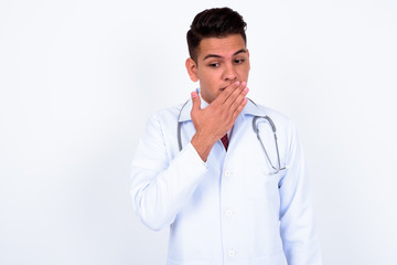 Portrait of young handsome multi ethnic man doctor