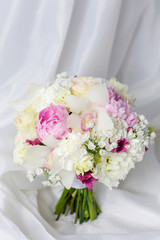 Beautiful wedding bouquet on white fabric background