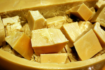 Parmesan cheese chopped into slices inside a cheese circle