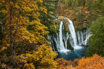 Fototapeta na wymiar Falls Color - A multitude of colors surrounds Burney Falls during the autumn season. McArthur-Burney Falls State Park, California, USA