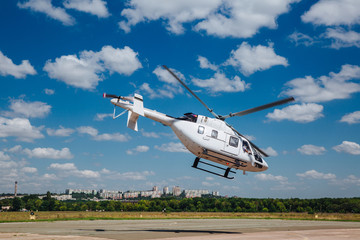 A white helicopter takes off from the runway © Oleksii Halutva