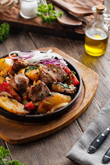 Baked beef with vegetables in cast iron pan