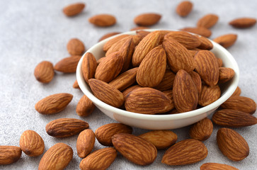 Close up,Almonds in a white bowl on gray background,copy space.