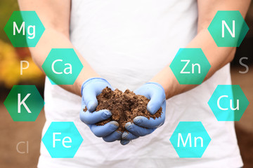 Man with heap of rich soil outdoors, closeup