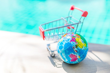 New global online shopping concept, world hand stress releif massage ball with empty shopping cart...