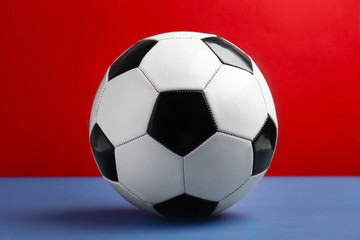 Naklejka premium Soccer ball on color background