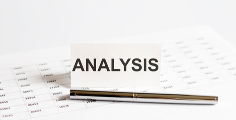 Text ANALYSIS on stickers,pen on the background of documents. Financial bookkeeping, Accounting Concept. Top view.