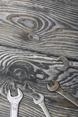 Spanners of various sizes on painted pine boards.