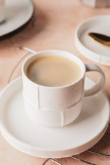 Cup of hot coffee on color background