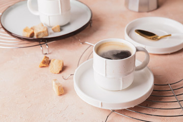 Cup of hot coffee on color background