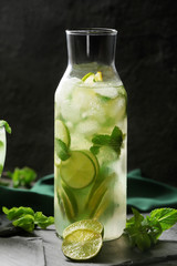 Bottle of fresh mojito on table
