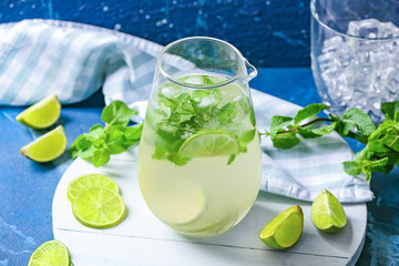 Jug of fresh mojito on table