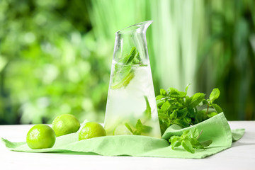 Composition with fresh mojito on table outdoors