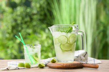 Composition with fresh mojito on table outdoors
