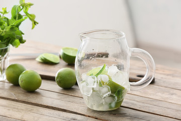 Making of tasty mojito cocktail at table