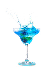 Glass of tasty blue mojito cocktail with splashes on white background