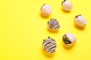 Tasty strawberry dipped in chocolate on color background