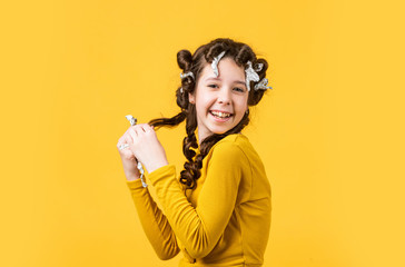 Child fashion model concept. childhood happiness. beauty and fashion. Child making hairstyle....