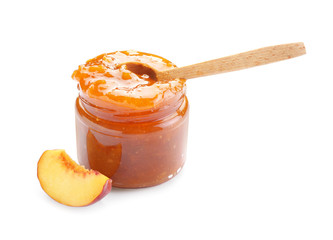 Jar of tasty peach jam on white background
