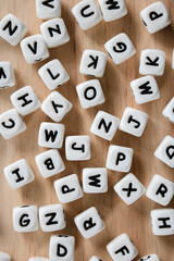 Text dice cube concept / Letter dices alphabet on wooden background. Block of alphabet studded on the floor.