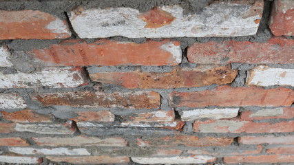 brick wall in oblique view with multi-colored bricks in structure and gray construction joints