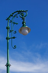 a very beautiful green lamppost with lots of ornaments