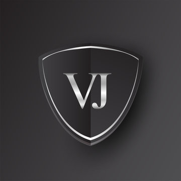 Initial logo letter VJ with shield Icon silver color isolated on black background, logotype design for company identity.