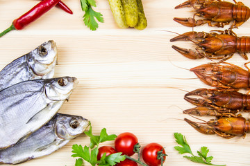 Composition with crayfish, dry fishes, pepper, tomatoes, parsley, pickled cucumbers. Cooking food background with free space for text. Top view with copy space