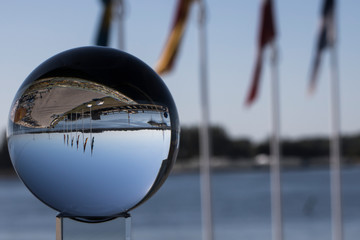 Fototapeta na wymiar Scanian landscape through lens ball (fortune ball)