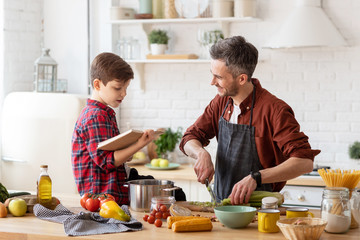 Happy father son spending time together on kitchen