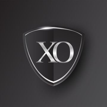 Initial logo letter XO with shield Icon silver color isolated on black background, logotype design for company identity.