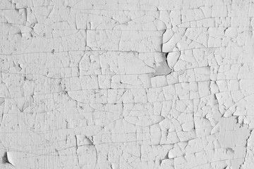 Peeling paint on the wall. Old concrete wall with cracked flaking paint. Weathered rough painted...