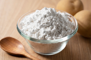 Potatoes and potatoes and a wooden spoon on the table