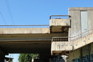 Pedestrian overpass stairs at the industrial district. Old cement stairs leading to the sidewalk on the bridge.