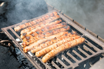 Sausages on the charcoal. BBQ outdoor. Fried meat sausages
