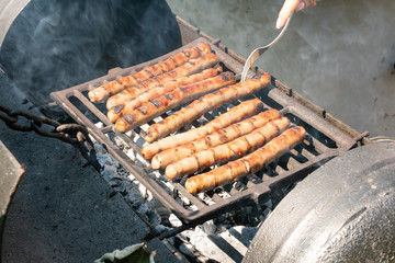 Sausages on the charcoal. BBQ outdoor. Fried meat sausages