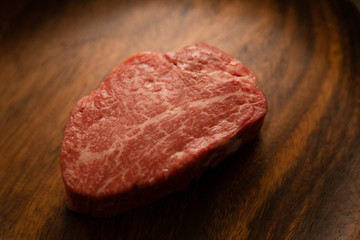 Raw meat on the wooden plate