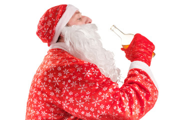 santa claus drinks alcohol from the neck of a bottle