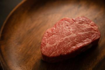 Raw meat on the wooden plate