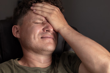 Fototapeta premium Close up of a man holding his head.