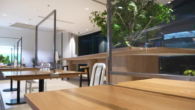 restaurant with table shield to protect infection from coronavirus covid-19, canteen partition and social distancing concept.