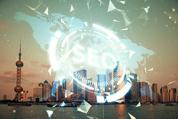 SEO hologram on city view with skyscrapers background double exposure. Search optimization concept.