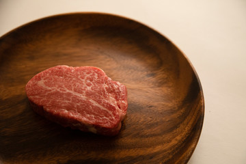 Raw meat on the wooden plate